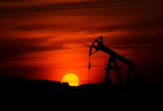 Pumpjack silhouetted against the setting sun